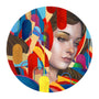 A circular artwork inspired by Erik Jones features a womans calm expression amid abstract, colorful geometric shapes. The vibrant background showcases overlapping forms in red, blue, yellow, and orange.