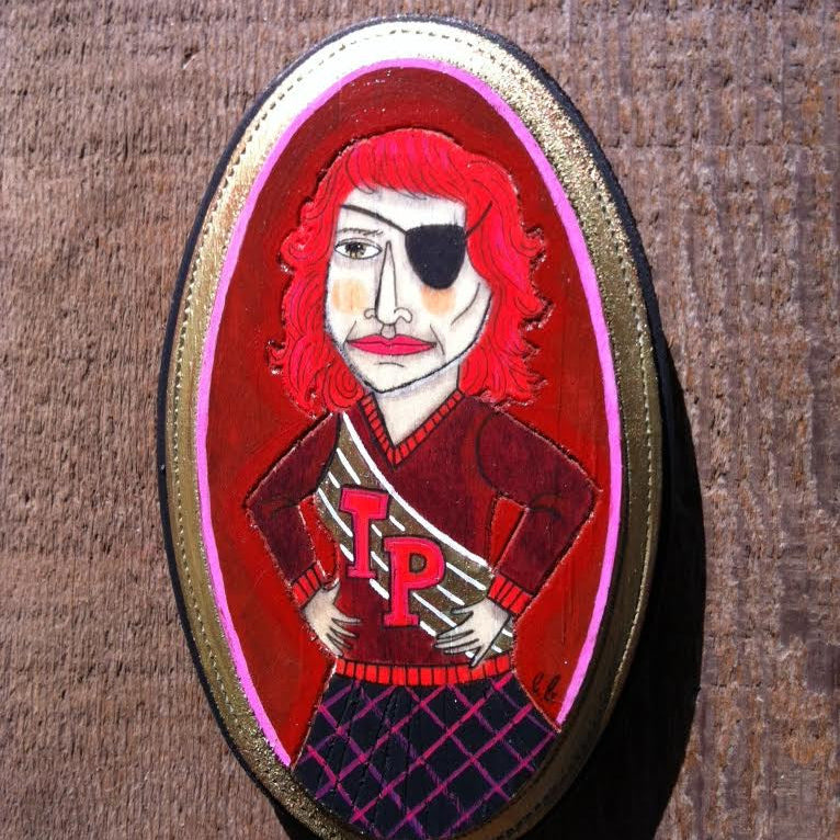 An Evan Harris mixed media painting showcases a red-haired person in a pirate outfit with an eyepatch, set within an oval frame. They wear a red JP jacket and stand confidently against a wooden backdrop.