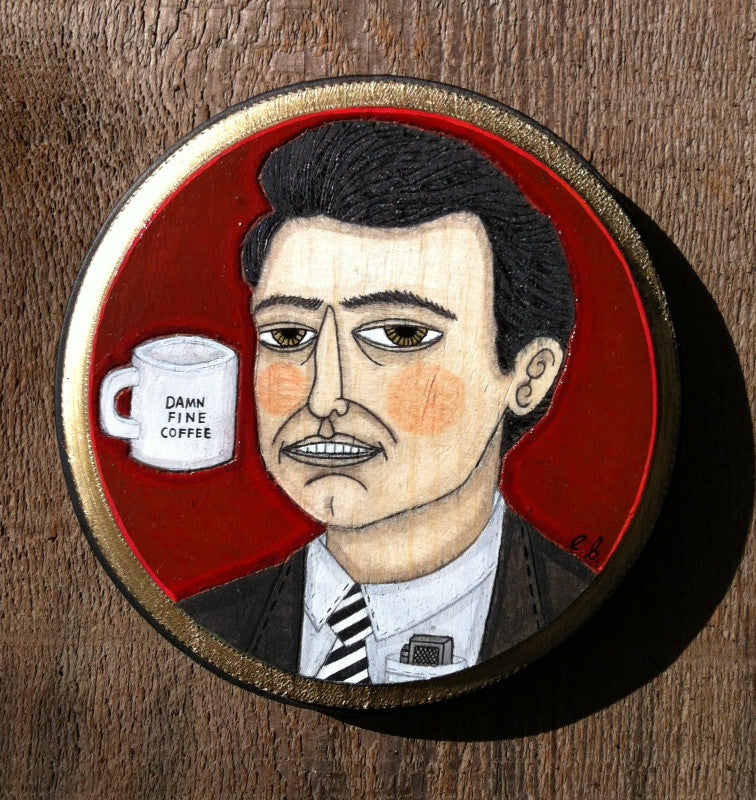Evan Harriss mixed media art features Agent Cooper in a suit with slicked-back hair holding a DAMN FINE COFFEE mug. The red background enhances its stylized, slightly abstract look.