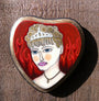 A heart-shaped mixed media artwork by Evan Harris features a portrait of a person with short, curly hair wearing a tiara. Against an abstract, red flame-like background, it is displayed on wood at Spoke Art Gallery.
