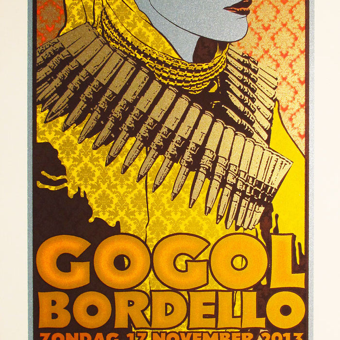 Chuck Sperrys poster for Gogol Bordellos concert on Sunday, November 17, 2013, at Paradiso Amsterdam features a stylized portrait with an exaggerated yellow coat and bullets draped around it, set against an orange and yellow patterned background.