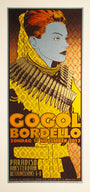 A Chuck Sperry stylized concert poster for Gogol Bordello, featuring a person with a bold hairstyle and detailed collar in orange, yellow, and grey. It highlights their Paradiso Amsterdam show on November 17, 2013.