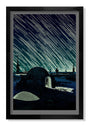 Framed artwork by Tim Doyle is a glow-in-the-dark screen print showing a sci-fi night scene with a small lit dome on a barren landscape under skies filled with streaks like shooting stars or rain. It belongs to a signed and numbered edition.