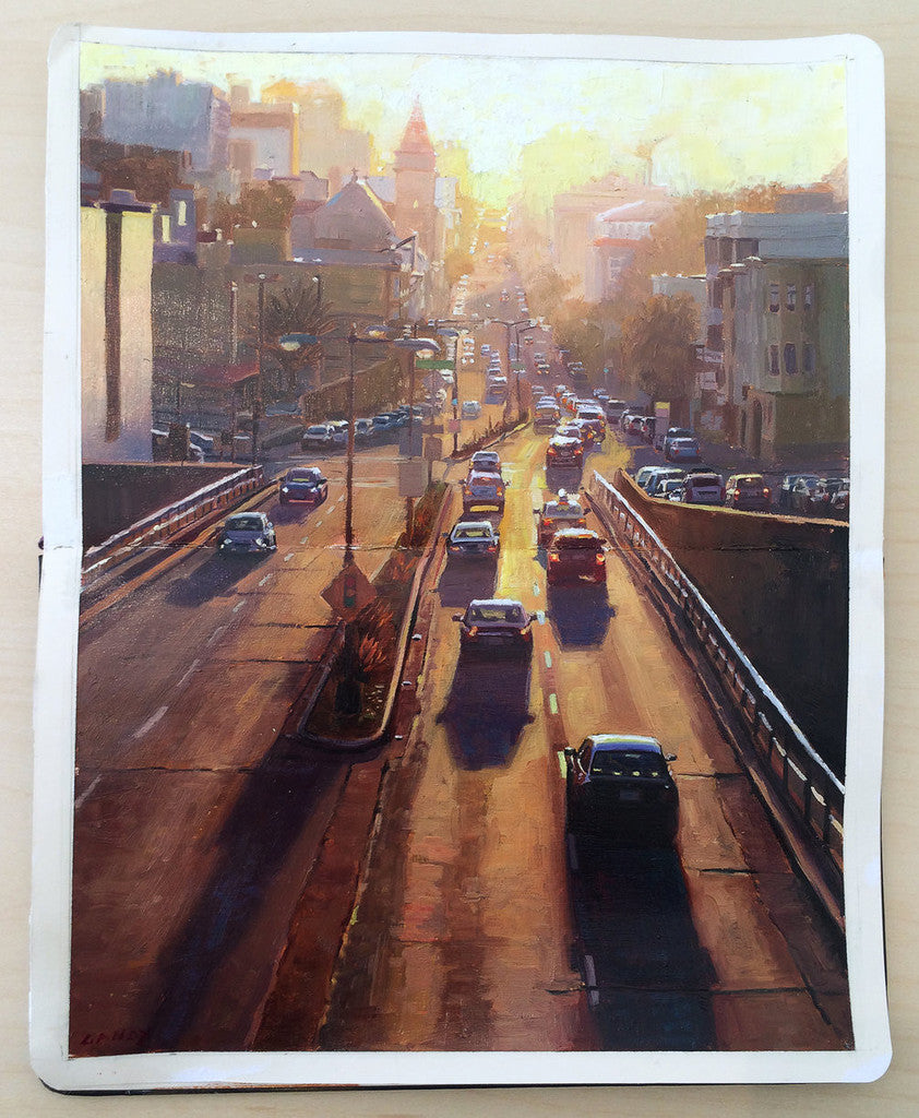 A custom framed oil painting by Greg Gandy captures a city street at sunset, with cars on a road curving into the horizon. Buildings line both sides as the warm, golden light of the setting sun casts long shadows.
