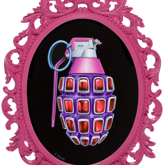 Scott Scheidlys Grenade #2, framed ornately in pink, showcases a jewel-like red segmented grenade painted in pink, purple, and silver against a black backdrop. View this striking artwork at Spoke Art Gallery.