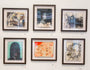 A gallery wall of six Shawn Barber custom-framed abstract artworks, including an Eye Study, displays various textures and styles featuring faces and earthy-toned abstract patterns, all neatly aligned in two rows.