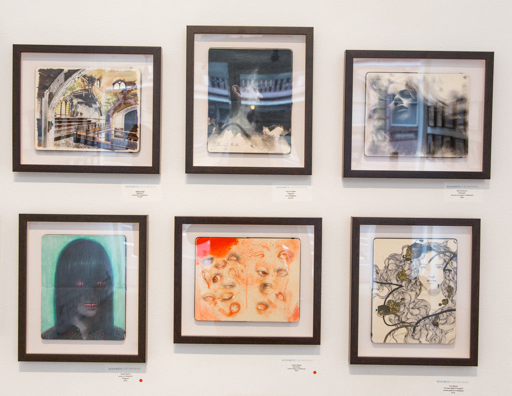 A gallery wall of six Shawn Barber custom-framed abstract artworks, including an Eye Study, displays various textures and styles featuring faces and earthy-toned abstract patterns, all neatly aligned in two rows.