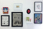 On display on Ocean Avenue 1932: a vibrant Conor Langton art exhibit showcasing colorful illustrations, framed sketches, and a small bunny-eared figure sculpture. A standout burger painting contrasts styles from cartoonish to realistic, immersing you in Langtons vivid world.