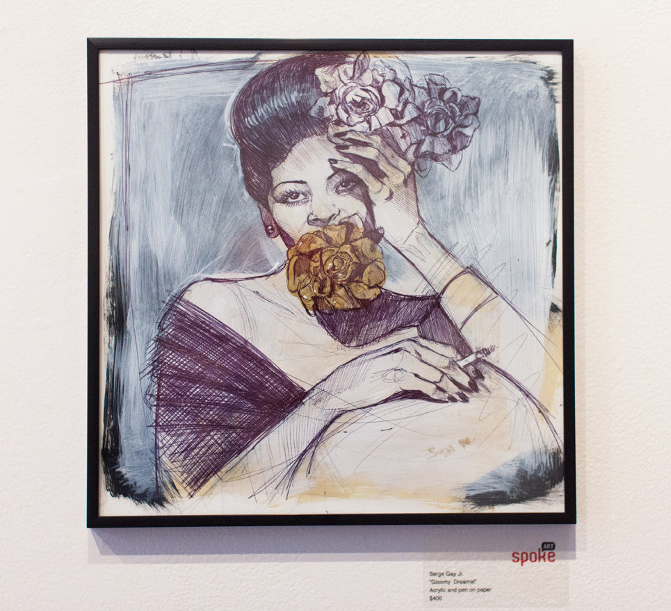 A Serge Gay Jr. framed artwork shows a person with stylized hair adorned with flowers, holding a golden flower in their mouth and a purple one in hand against a soft gray and white backdrop.