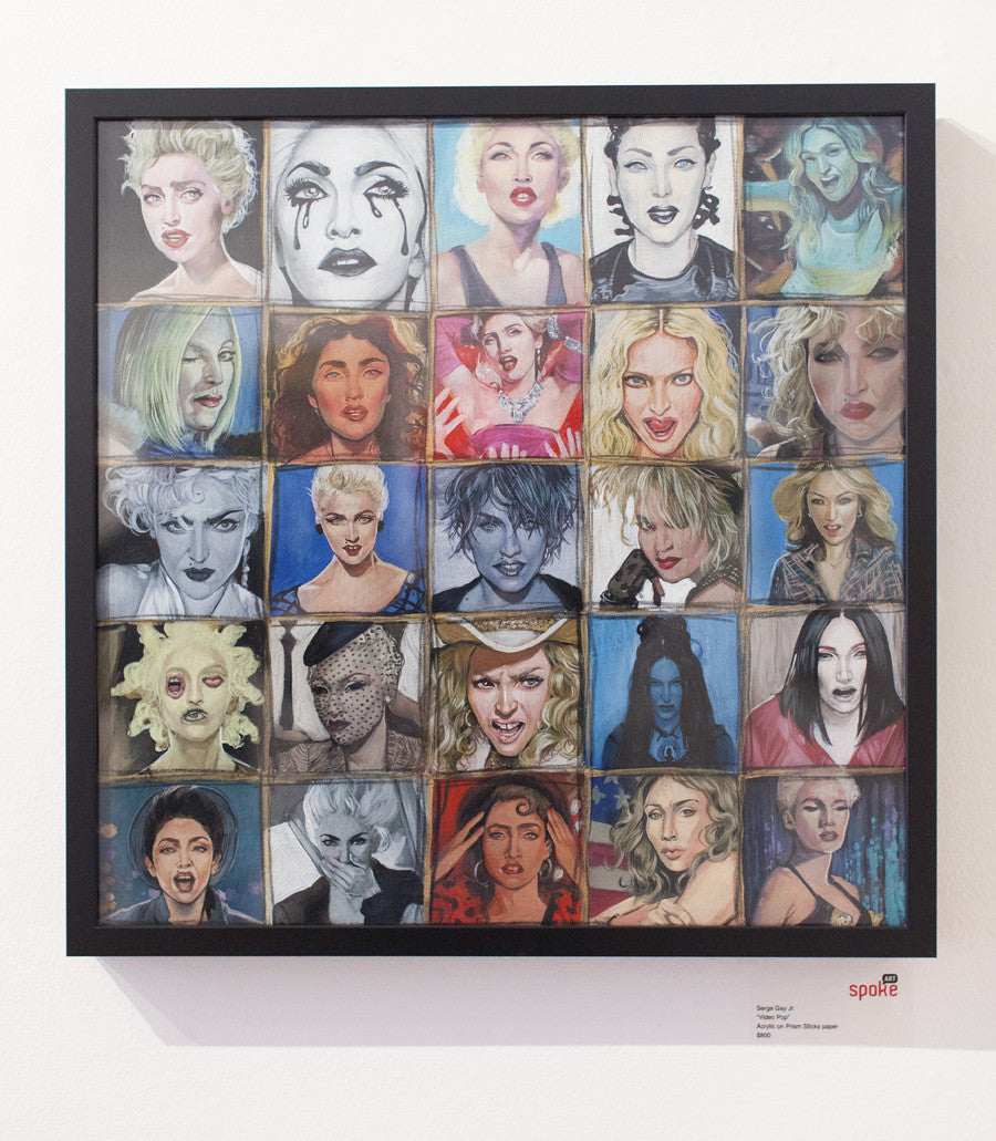 A striking framed artwork by Serge Gay Jr. features a grid of 25 portraits, each showcasing a unique expression or style of a blonde-haired woman. The vibrant collection varies in color and mood, reflecting his renowned Video Pop flair.