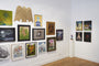 A gallery wall showcases framed artworks, from abstract designs to portraits, including oil paintings and illustrations. Above it all, a sculpture of an eagle adds prominence, echoing the evocative essence of Suggestivism: Resonance by Jon Fox.