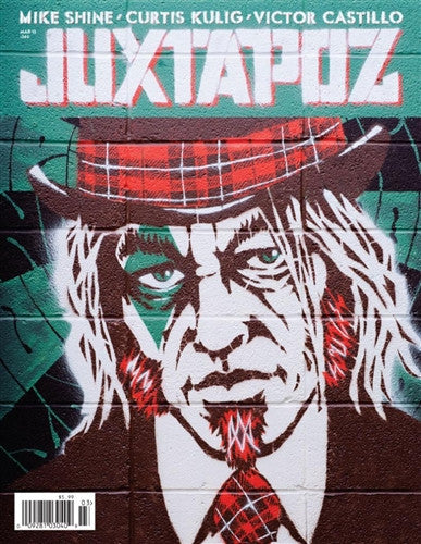 Juxtapoz magazines cover features a street art mural of a stylized man in a suit with a red plaid top hat and solemn expression, set against green and black tones.