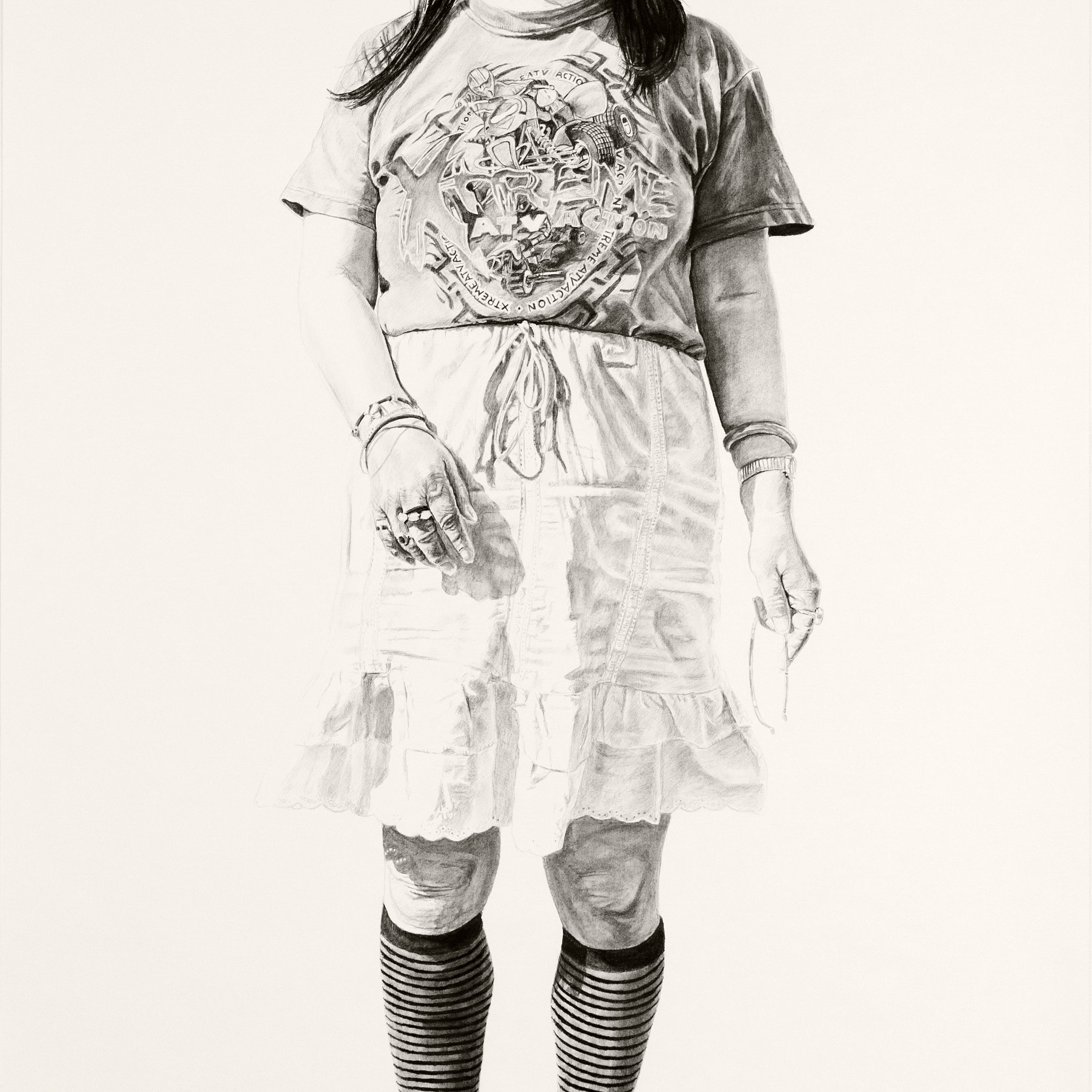 Charcoal and graphite sketch by Joel Phillips features a person with shoulder-length hair in a T-shirt, knee-length skirt, striped knee-high socks, and open-toed shoes. Inspired by the vibrant San Francisco art fairs, the figure stands against a plain background.