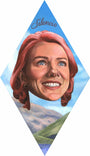 Silencio, an acrylic on wood by Johannah ODonnell, features a surreal diamond-shaped design with a smiling woman’s floating head with pink hair set against blue sky and hills.