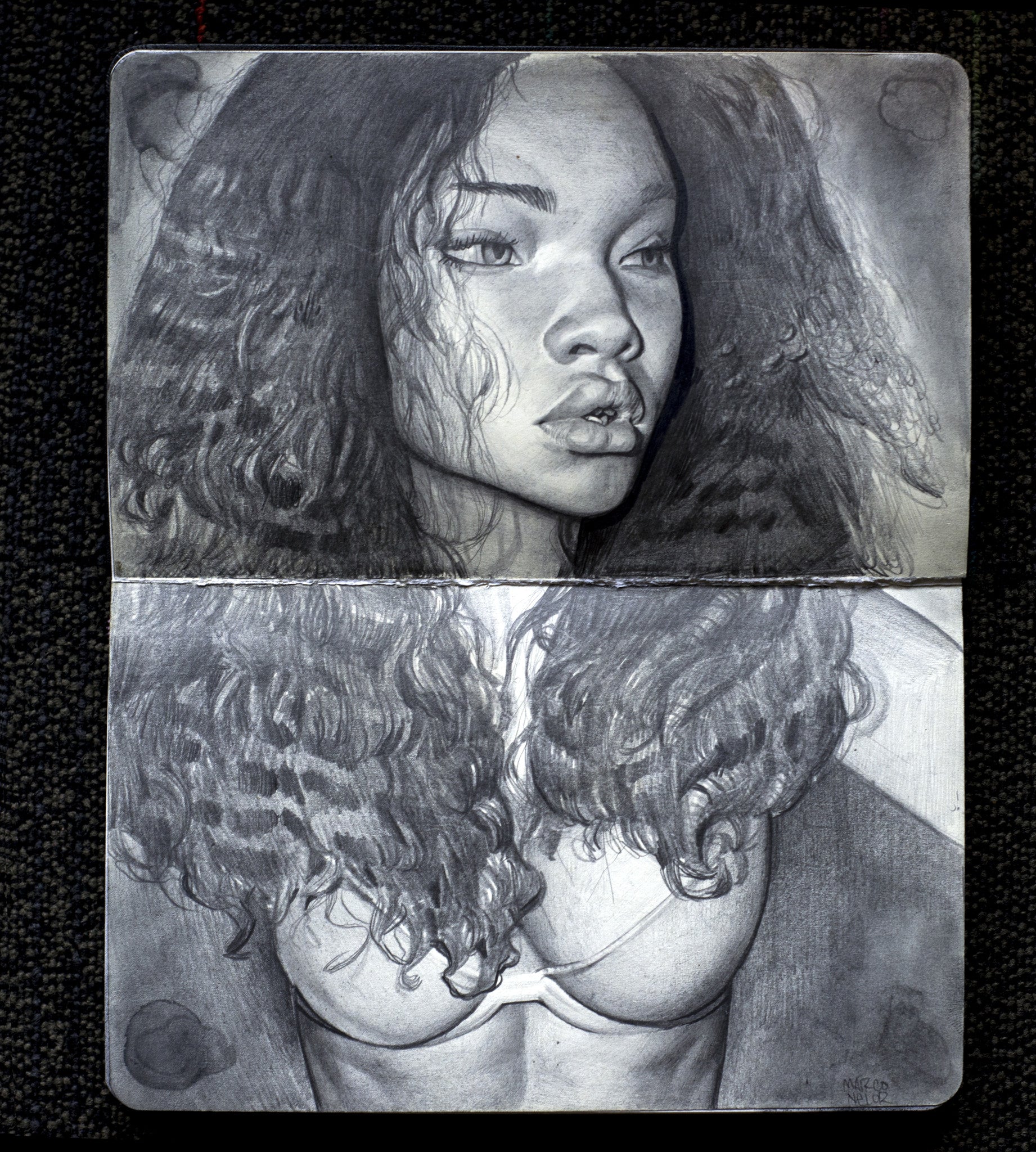 Marco Nelors detailed pencil portrait, Ashley Study, features a contemplative woman with long, wavy hair in a bra. The drawing is displayed on a textured dark surface within an open sketchbook.