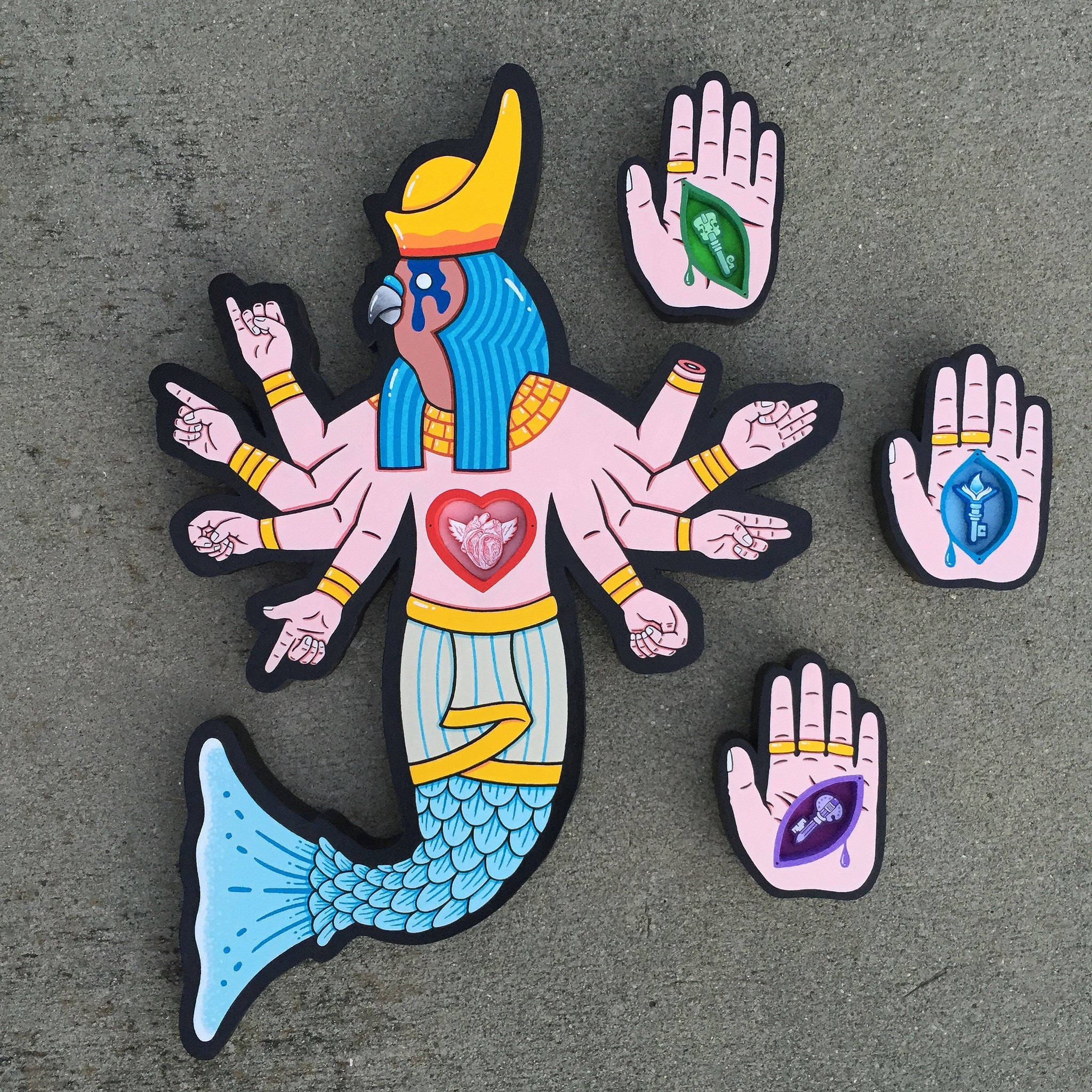 This lively Matt Ritchie piece features a mythical creature with a mermaid tail, multiple arms, and an Egyptian-style headdress. Crafted in acrylic on cut wood, it showcases symbolic hand signs and floating hands with a snake, heart, beetle, and leaf that capture the playful essence of Idol Fun.