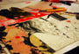A close-up of an art project on a table showcases a detailed pencil drawing, echoing the style of Nimit Malavia, with a person amidst vivid abstract patterns and geometric shapes. Various drawing tools and papers are scattered around, inspiring creativity similar to pieces at Spoke Art Gallery.