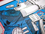 A close-up of an abstract, colorful design reminiscent of a Tim Doyle print featuring machinery elements. A blue shirt with a POLICE badge partially peeks through, enhancing the layered effect, as if it were a signed and numbered screen print.