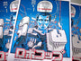 Tim Doyles stylized screen print poster showcases a futuristic character with robotic elements in a blue suit and wires extending from the head. It is signed, numbered, and features prominent Japanese text at the bottom against a blue background with white and red accents.