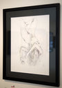 The framed pencil sketch Love Without Limits by M Ian Dringenberg features an elegantly reclining figure in graphite and charcoal. With minimal detail and delicate shading, the abstract style presents the upside-down figure beautifully against a white wall.