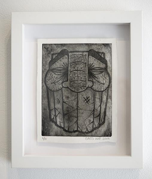 A custom-framed black and white artwork by GATS features a stylized face with intricate patterns, large eyes, and bold geometric elements. This piece embodies Bridge City flair and is signed GATS 2014 at the bottom.