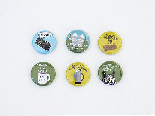 Arthurs Plaid Pants offers a Twin Peaks-themed set with six buttons and a magnet, featuring iconic designs: Diane... with a tape recorder, Welcome to Twin Peaks, Do Not Introduce the Log, Damn Fine Coffee and Hot, Theres a Fish in the Percolator, and The Owls Are Not What They Seem.