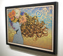 This limited edition artwork by Chuck Sperry, crafted on an oak panel, showcases a stylized woman with flowing hair interwoven with colorful flowers, set against a background of swirling blue and gold wave-like patterns reminiscent of his Naiad style.
