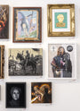 A PJ McQuade wall display features framed artwork: a wizard, medieval warriors inspired by George R.R. Martin, a Brienne of Tarth lookalike, a stern face, and a fire-breathing creature; frames ranging from simple to ornate.