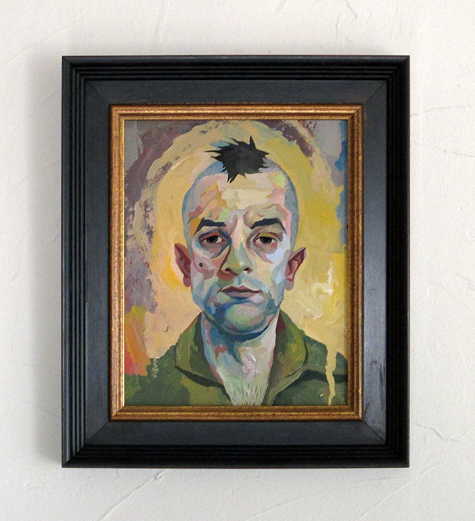 A framed art piece by Rich Pellegrino features a serious man in vibrant abstract style. Colorful brushstrokes highlight his face and green attire against a pastel background, reminiscent of Spoke Art gallerys flair.