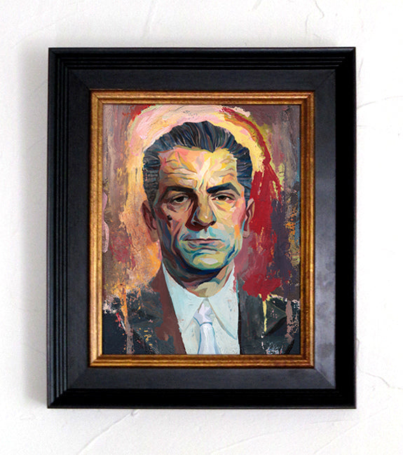 A framed portrait by Rich Pellegrino features a serious man in a suit and tie, painted with bold brushstrokes. The mix of red, orange, and neutral tones enhances the vibrant style reminiscent of Martin Scorsese fan art.
