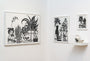 The display showcases three black and white botanical artworks in frames, with intricate ink on paper details by Bagger43. One features a skull amid potted plants. A small white shelf holds two abstract ceramic vases, creating a minimalistic display reminiscent of Spoke Art Gallerys aesthetic.