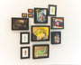 A gallery wall showcases framed illustrations and photos of vintage toys—action figures, dinosaurs, and toy vehicles—against a white backdrop, displaying vibrant hues akin to Spoke Art Gallerys oil canvases. These pieces are by the brand Allan Innman.