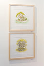 Two framed illustrations hang on a wall: The top by Nicole Gustafsson shows animals and a child under a tree, and the bottom features animals around an arboreal island with yellow foliage. Both are enclosed in light wood frames.