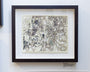 Rodneys Dilemma Revisited, a framed pen drawing by Barron Storey, showcases intricate line work with abstract shapes and scenes in ink and acrylic on a Moleskine base. A small plaque provides artwork information.