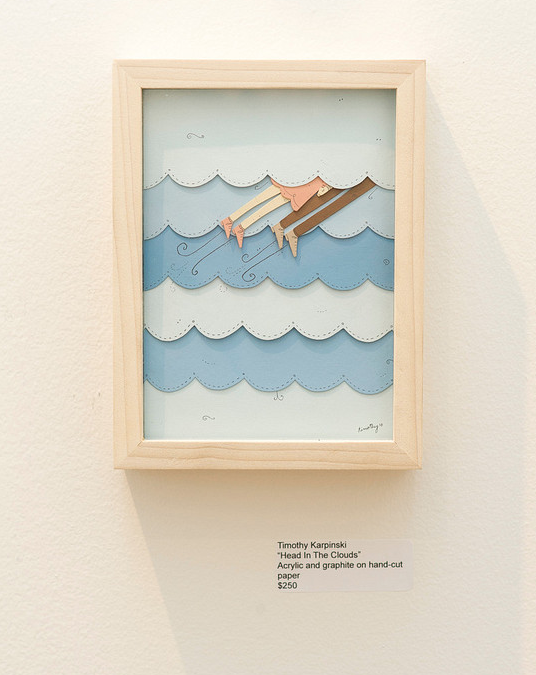 The artwork Head in the Clouds by Timothy Karpinski features two people on a branch with blue clouds, crafted with acrylic and hand-cut paper. Priced at $250, payment plans are available.