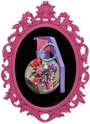 An oval pink ornate frame from Scott Scheidlys The Pinks at Spoke Art Gallery features a hand grenade with vibrant pink and purple flowers on a black backdrop, showcasing his signature style with the pin and handle visible.