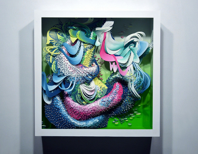 Crystal Wagners vibrant abstract art, inspired by Bio Interloper VI, showcases swirling patterns in blue, pink, green, and yellow. This dynamic piece captures the essence of a screen print and is elegantly framed in white against a plain wall.