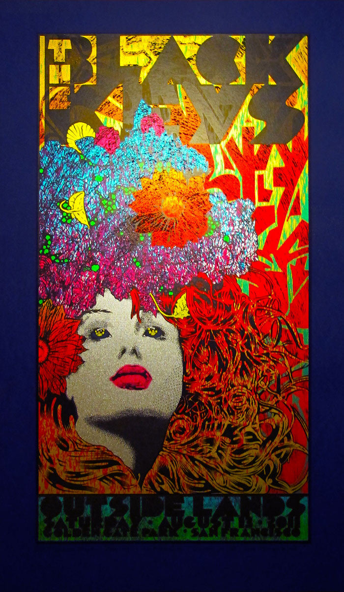 A vibrant Chuck Sperry-inspired psychedelic poster with vivid abstract artwork features a stylized womans face adorned with floral and geometric patterns. Bold text at the top echoes The Black Keys style from Outside Lands 2011.