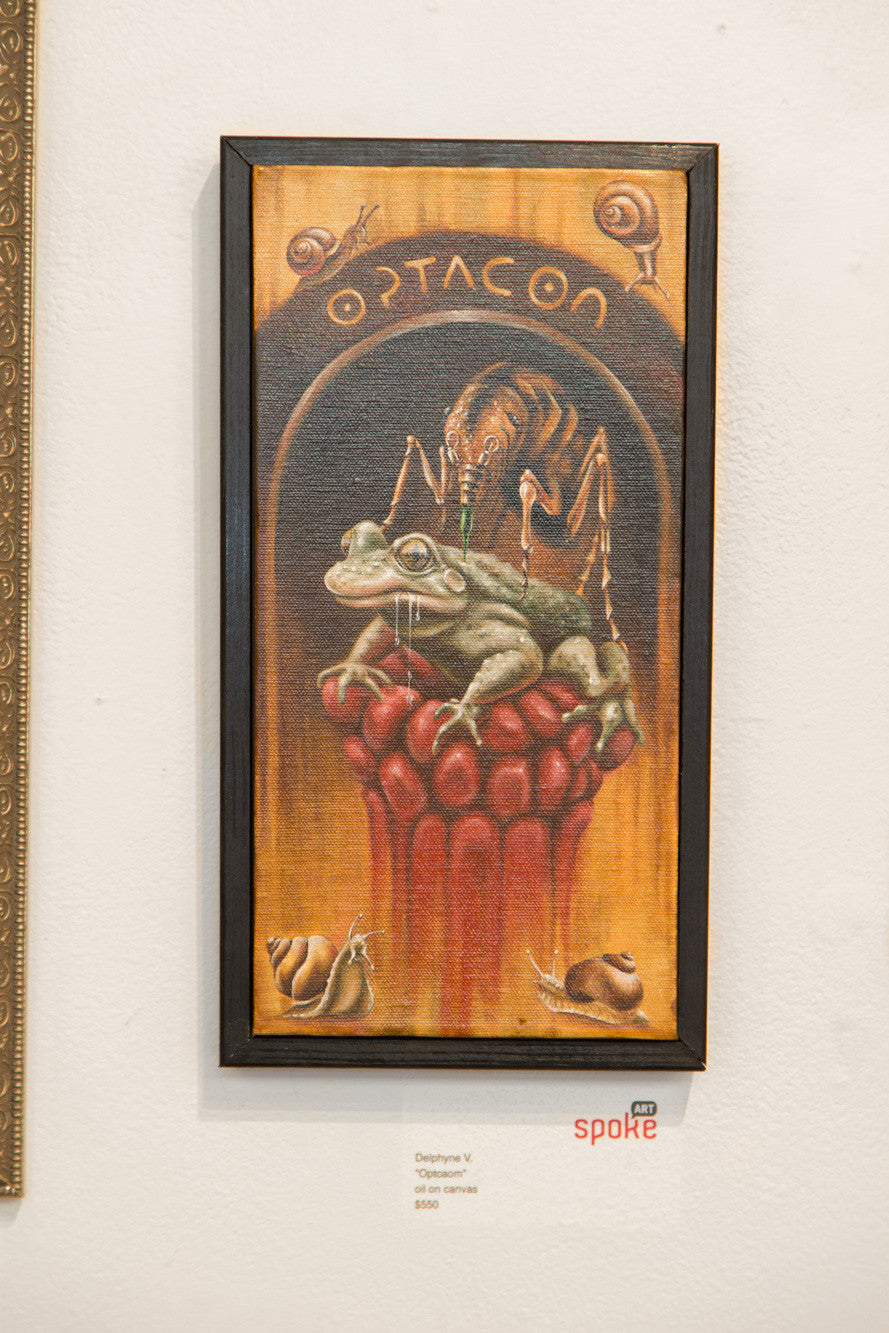A framed surreal oil on canvas from Delphyne V. showcases a frog with a human-like expression sitting on a goblet of red spheres, beneath an arch labeled OPTCAOM, surrounded by a spider and snails. Priced at $800, this intriguing piece captures attention.