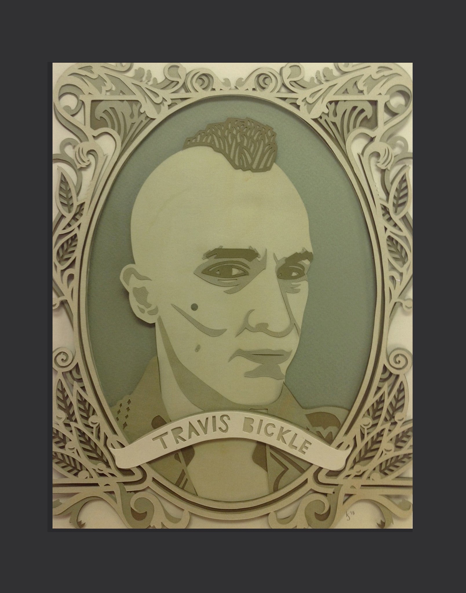 Kevin J Stantons paper-cut portrait of a person with a mohawk, framed in swirling designs, honors TRAVIS BICKLE and Scorseses art show. Layered textures in beige and green capture the manic vigilante spirit beautifully.