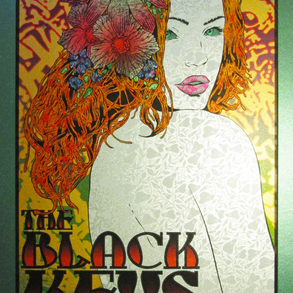 A vibrant concert poster by Chuck Sperry for The Black Keys features a floral-haired woman. It includes details of the event on November 5, 2014, at Oracle Arena, Oakland, CA, with Jake Bugg as the special guest.