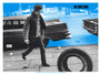 A person walks next to a vintage car and an upright tire on a blue backdrop with NO DIRECTION and HOME text. This Tim Jordan limited edition screen print evokes the nostalgic, retro vibe of a Martin Scorsese cinematic tribute.