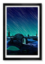 A framed Tim Doyle illustration from a signed, numbered series showcases a sci-fi scene in glow-in-the-dark screen print. It depicts a dome-shaped building under night skies with shooting-star-like streaks illuminating two figures against a dark blue to green gradient.