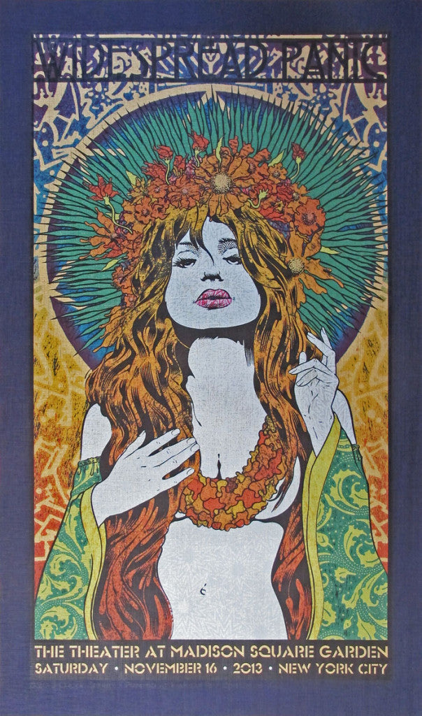 Vibrant poster by Chuck Sperry showcasing a woman with a floral headpiece and flowing hair in an intricately patterned dress. The text reads: Widespread Panic, The Theater at Madison Square Garden, Saturday, November 16, 2013, New York City.