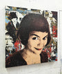 The canvas features a pop art-style portrait of a woman with a playful smile and short dark hair. Inspired by Greg Gossel, the background includes vintage magazine clippings and illustrations, adding retro flair. This acrylic painting nods to Amélies whimsical charm.