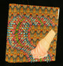 A 3D art piece by David Cooley showcases a vibrant, textured background with floral patterns. It features a vanilla soft-serve ice cream cone, crafted in acrylic art, seemingly blending into the intricate backdrop.