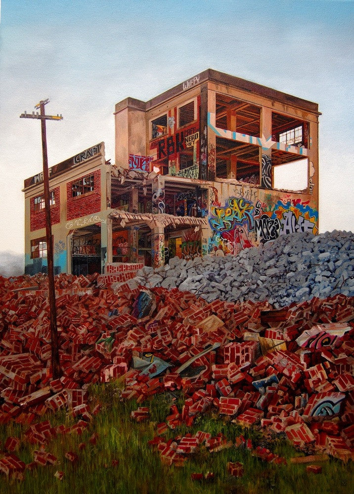 A dilapidated, graffiti-covered building with broken windows stands amidst scattered bricks, awaiting Demolition Day. A utility pole and greenery peeking through the debris create a scene reminiscent of a Jessica Hess oil on canvas.