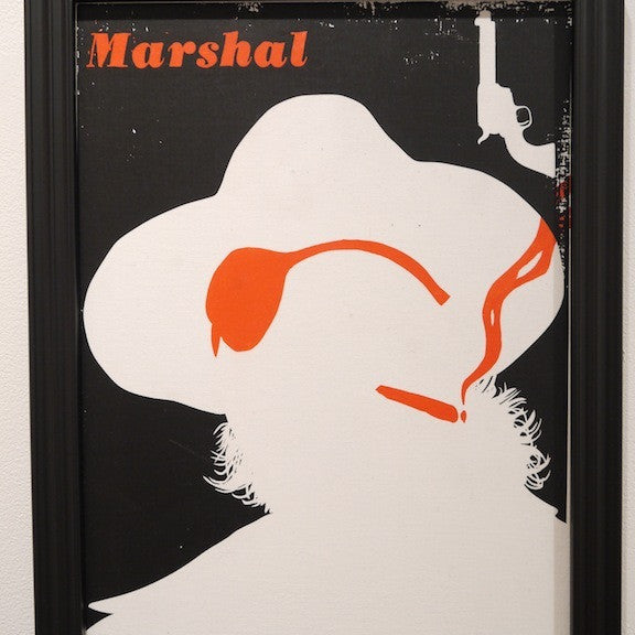 A silhouette of a person in a hat and eyepatch, set against black, illustrates Evanimals striking style. An orange Marshal at the top left and a revolver above evoke Spoke Art Gallery showcases.