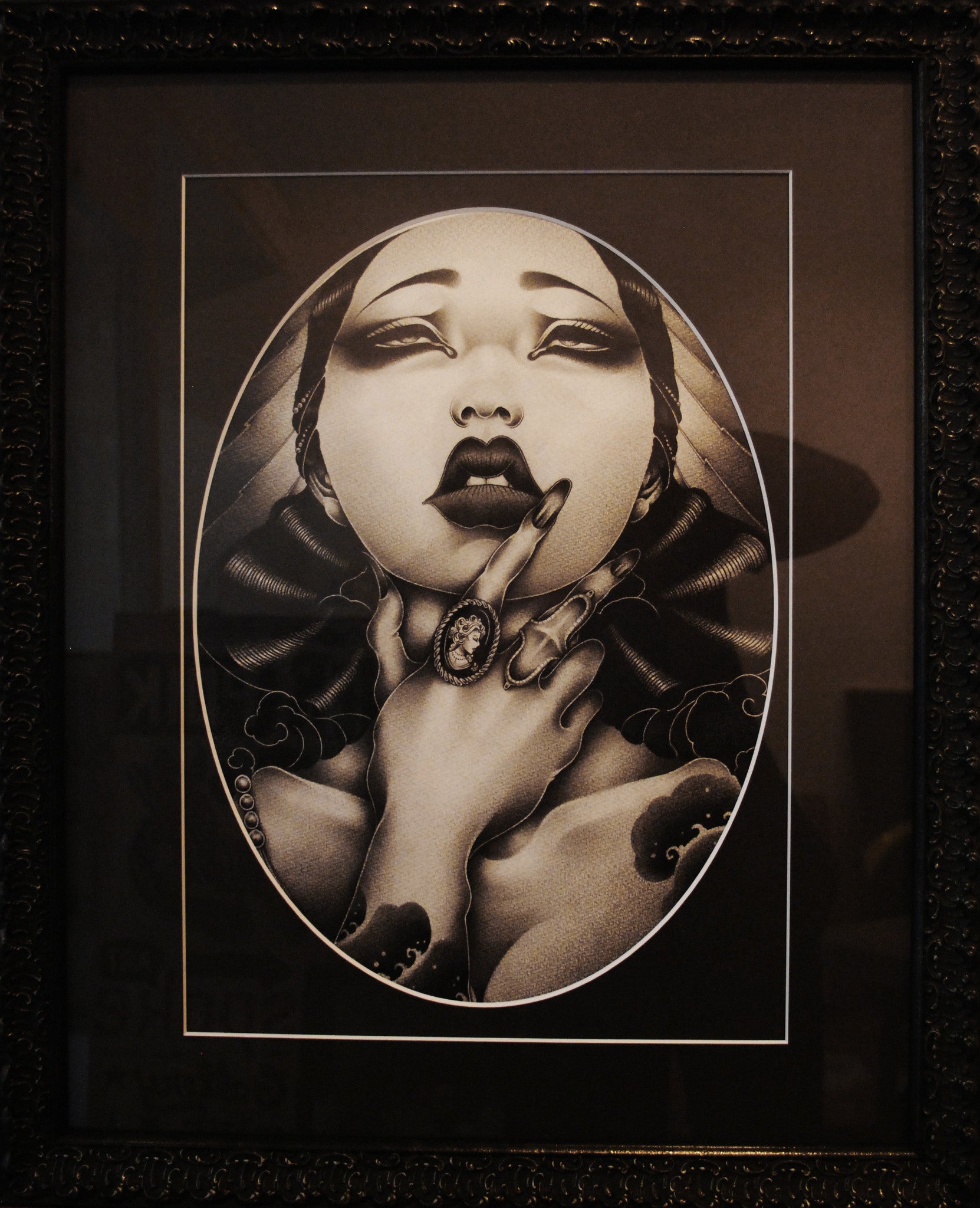 This captivating graphite on paper artwork by ONEQ showcases a woman with closed eyes and fingers near her lips, detailed hair, and ornate jewelry, all set against a dark background. Featured in the Supersonic Electronic Invitational, this black-and-white masterpiece is framed for display.