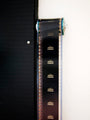 A roll of film on a reel is vertically displayed on a black board, capturing Room 237s mystique. The frames feature Stanley Kubrick in white against black, creating a minimalistic art installation that echoes the enigmatic style of the iconic director. Brand: Steve Yamane.